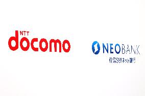 Signs and logos of NTT DoCoMo and SBI Sumishin Net Bank.